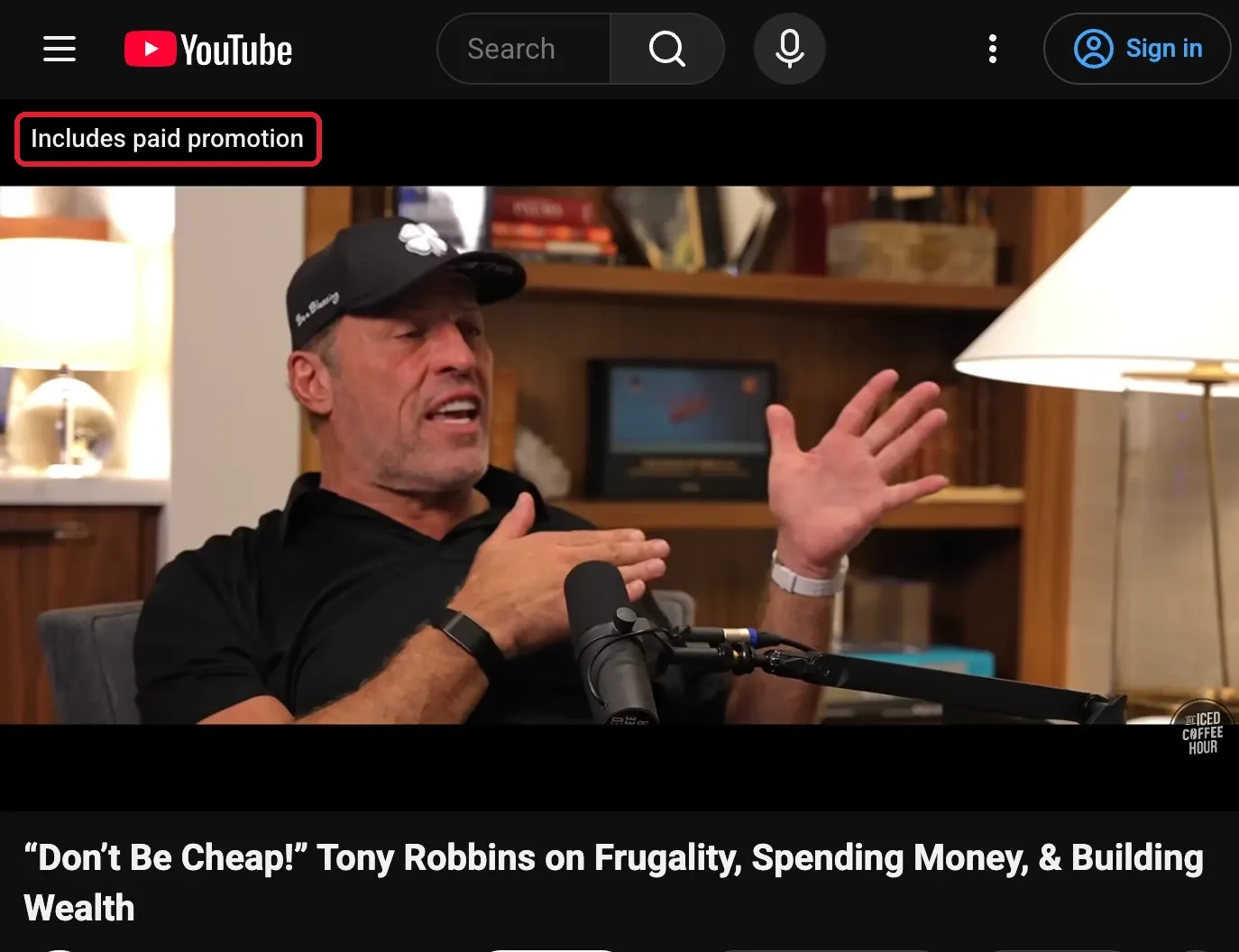 YouTube video page showing the "Includes paid promotion" label highlighted with a red box